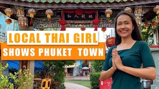 A local Thai girl shows Phuket Old Town. Thailand 2021.